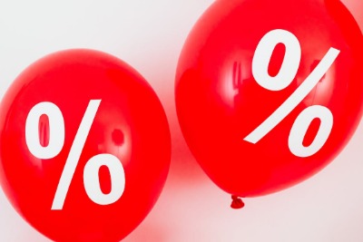 two red balloons with a percent symbol on them. 