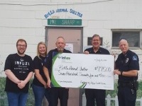 Group of people holding a donation check.