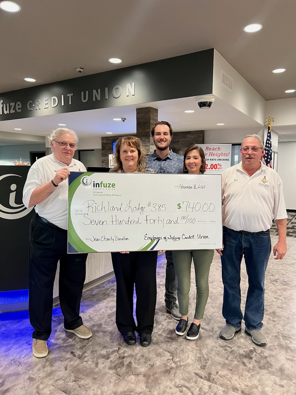 group of people holding novelty check.