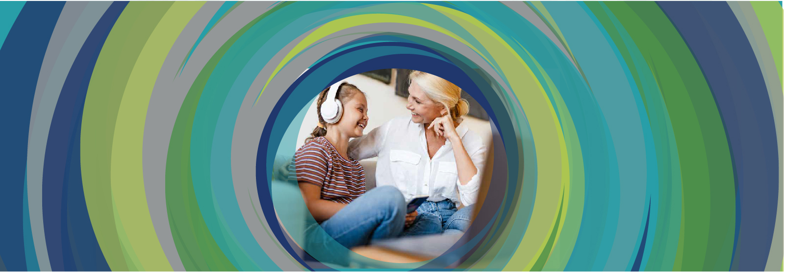 Woman and young girl with headphones laughing.