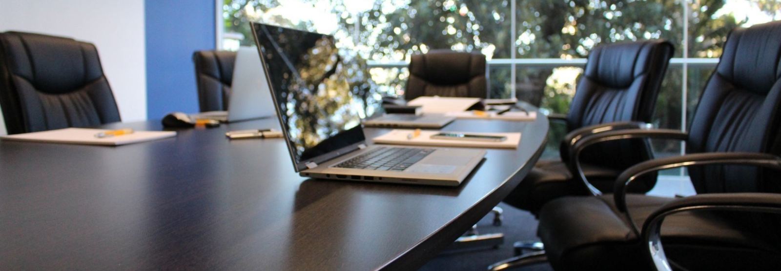 board room photo with a laptop on the table