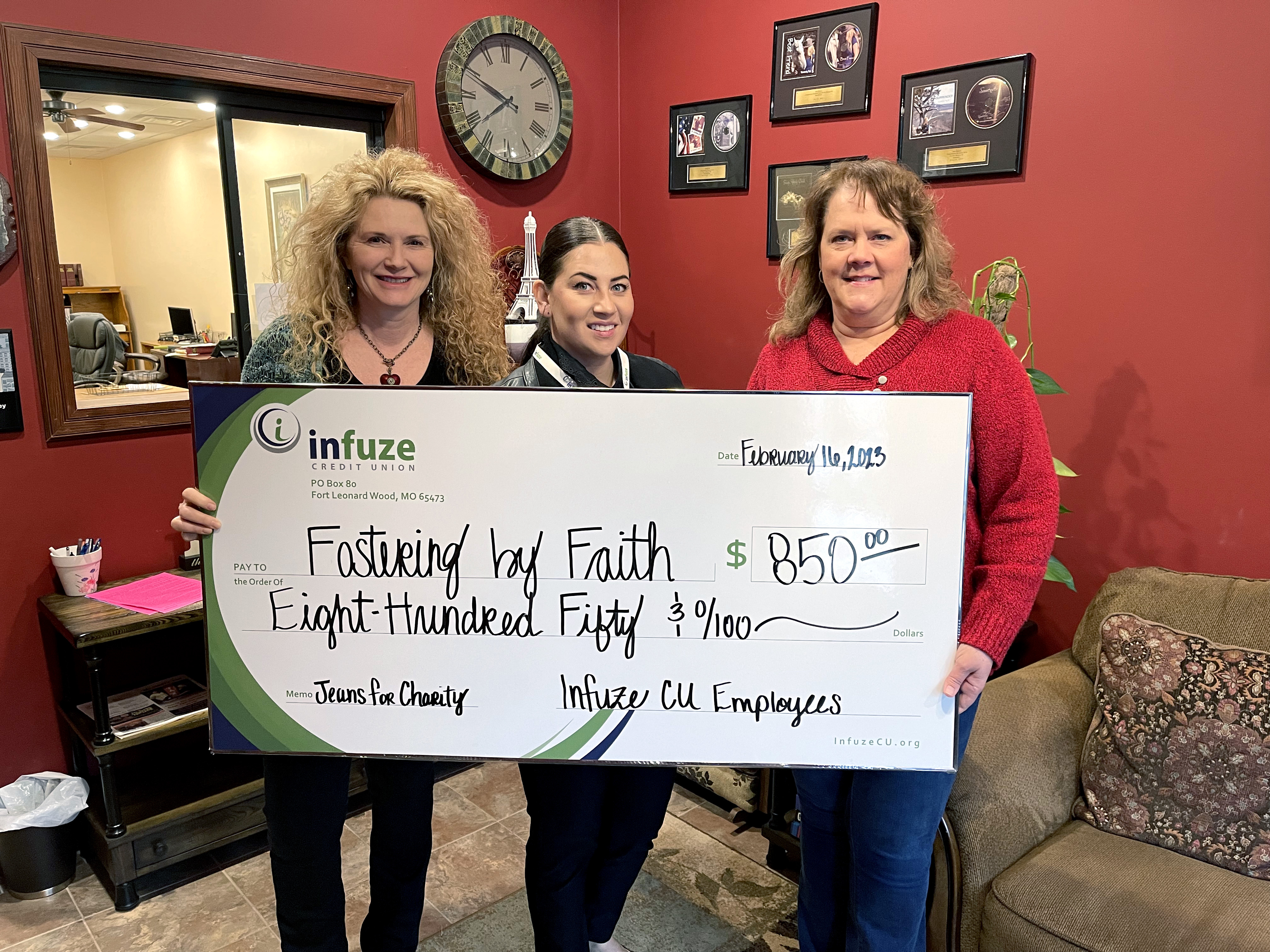 three women holding novelty check. 