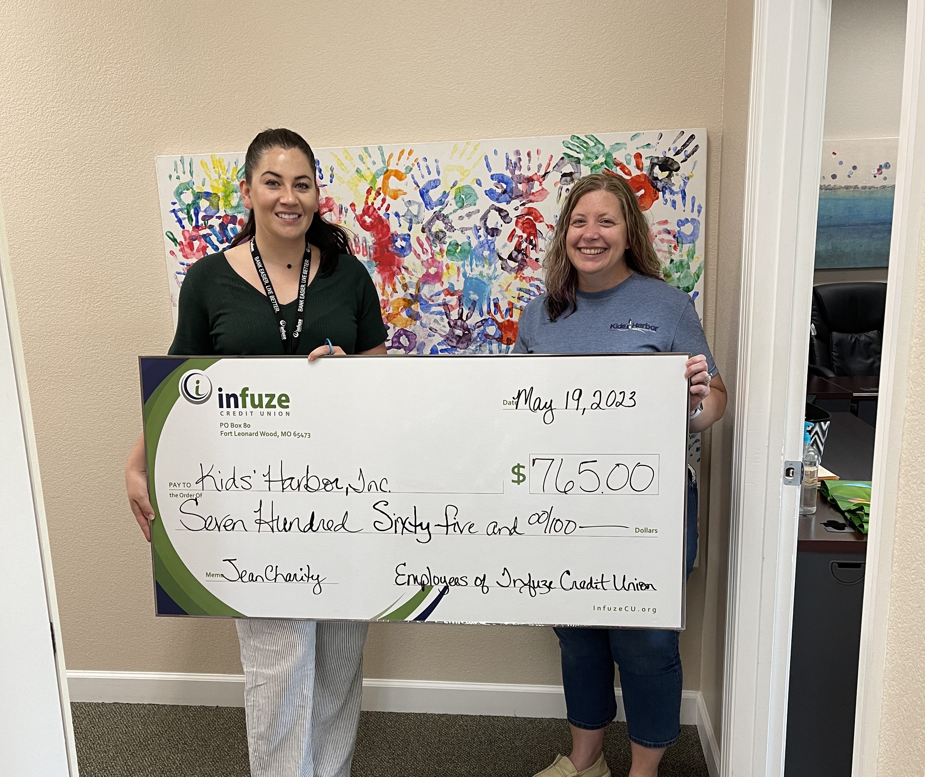 two women holding novelty check. 