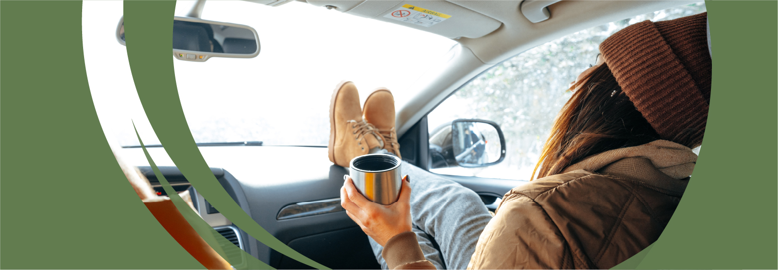 woman in passenger seat with feet up on car dash with cup of coffee.