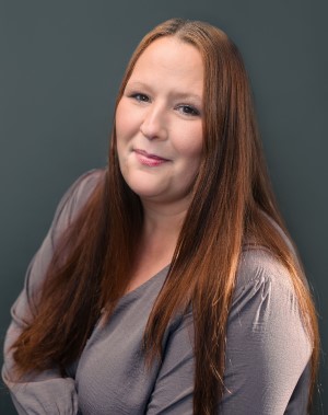 Portrait of female wearing gray shirt. 