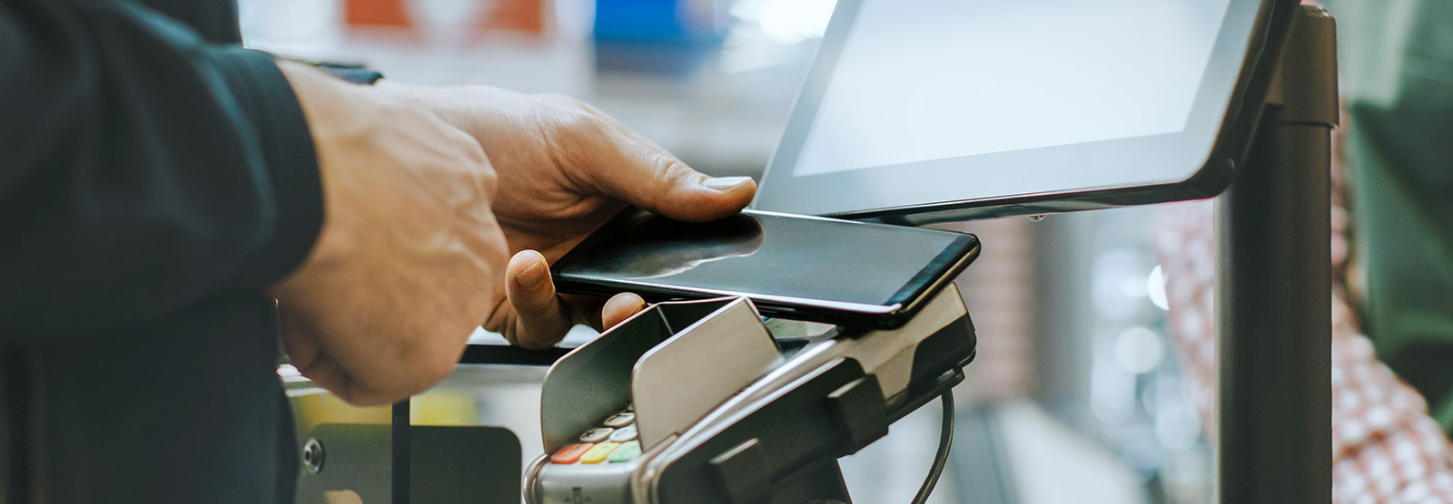 Person using digital pay at grocery store.