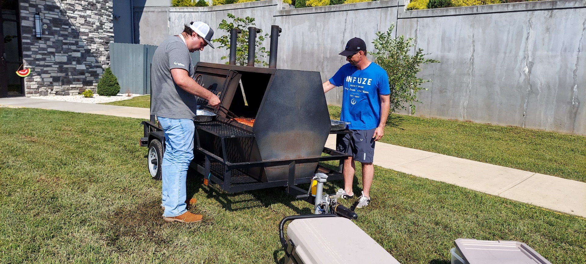 Two men grilling.