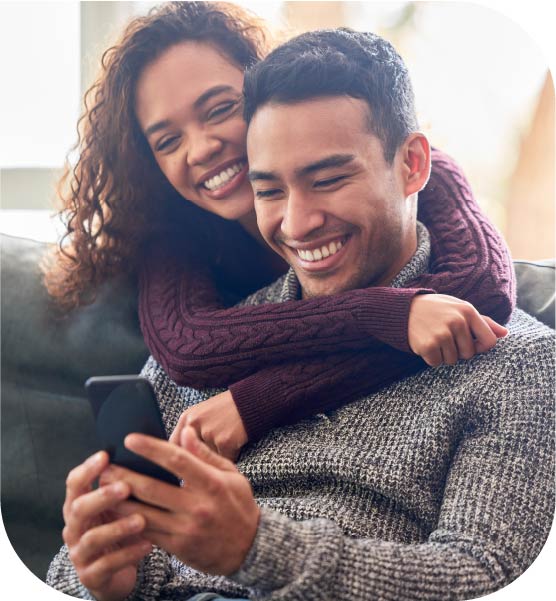 Happy couple looking at their phone.