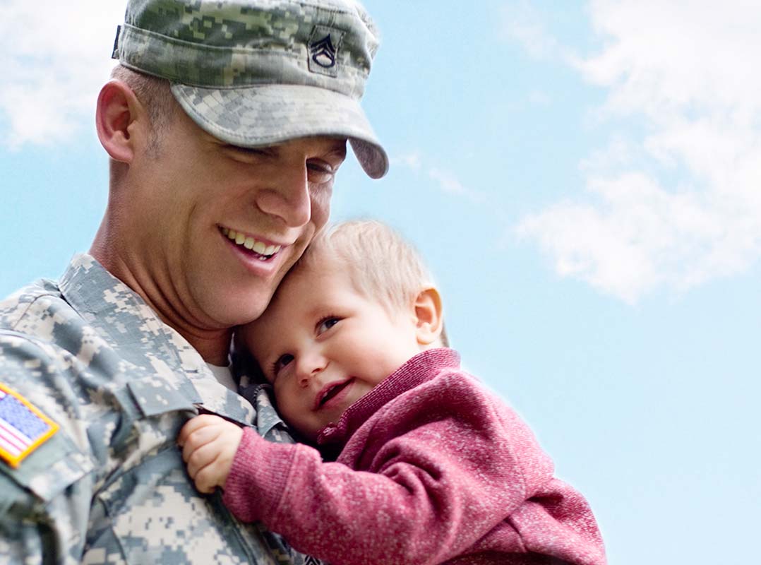 Military dad holding his son