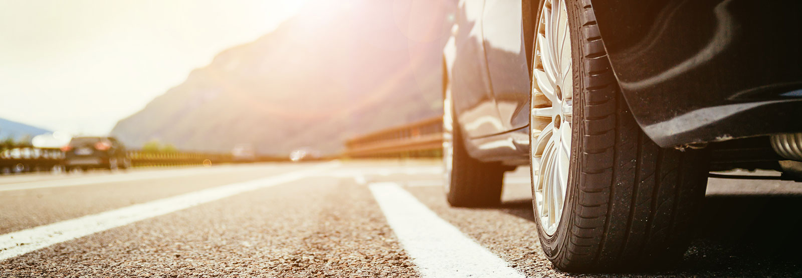 low angle of car on open road.