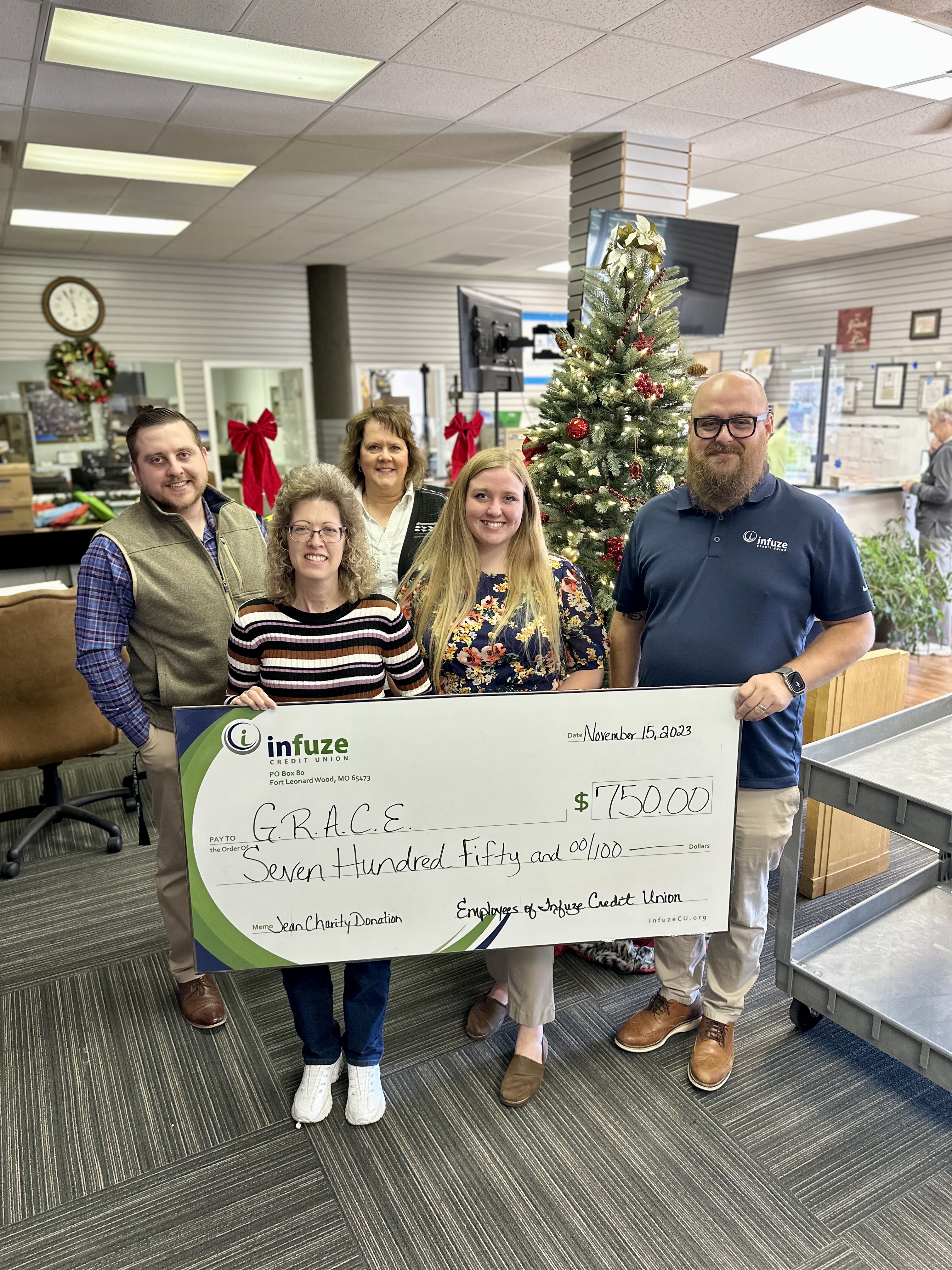 group of people holding novelty check. 