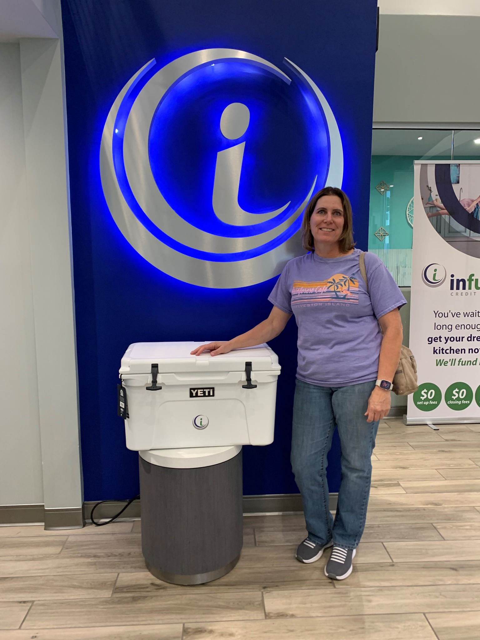 Woman standing by ice chest.