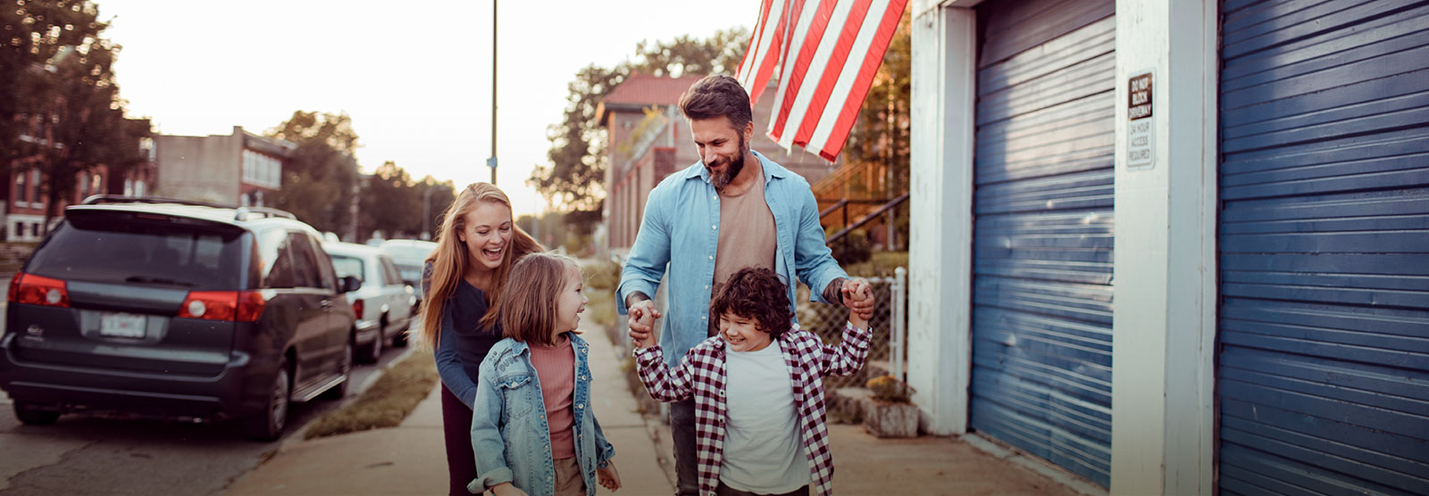 Family walking together in small town.