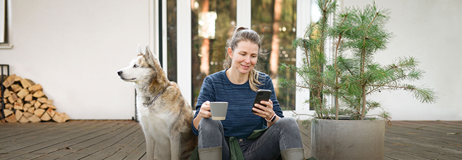 Woman on porch with coffee and phone