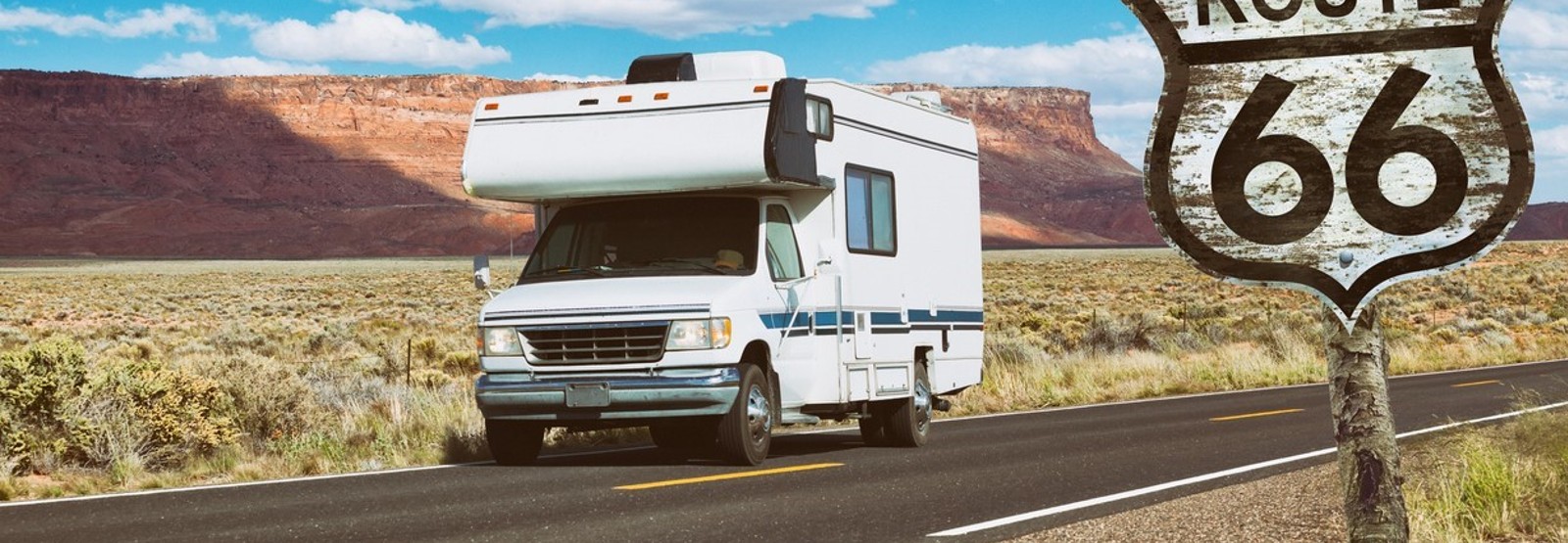 Image of RV driving and a Rt. 66 sign. 