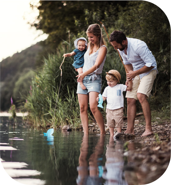 Young family at a river shore line.