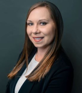 Portrait image of female wearing dress jacket. 